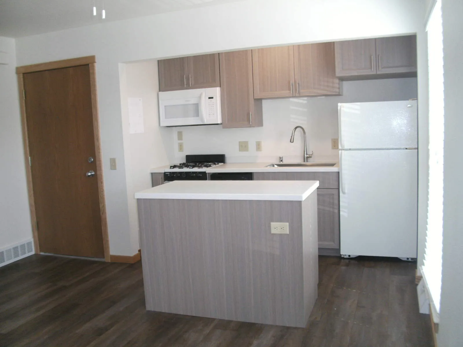 One-bedroom apartment galley kitchen with an island