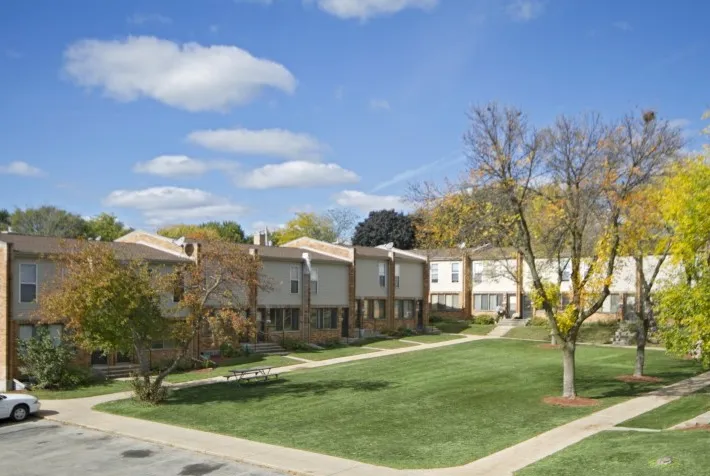 Townhome rows facing a shared lawn and walking paths