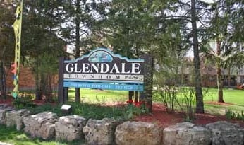 The Glendale Townhomes entrance sign on a stone wall
