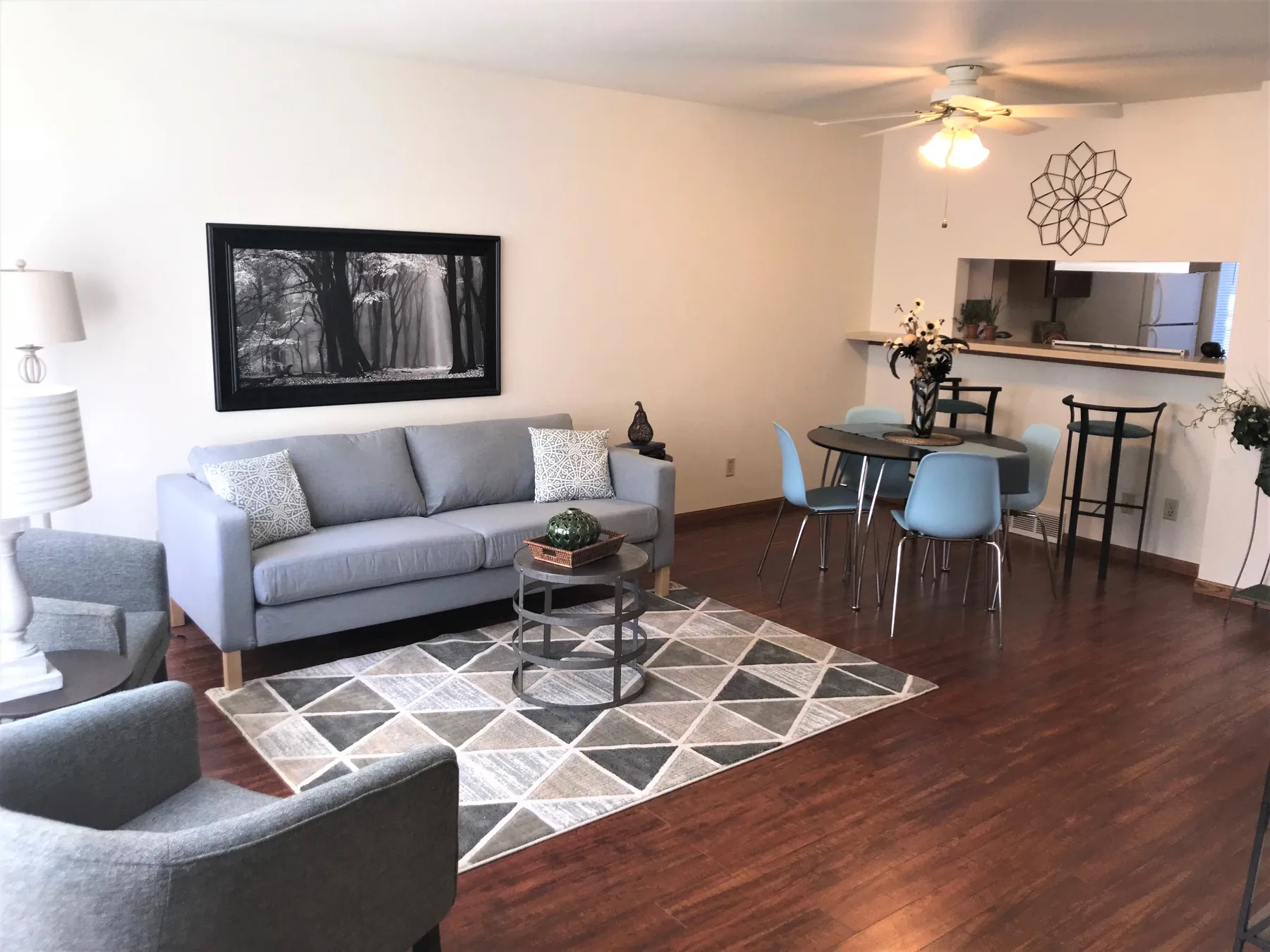 Townhome living room and dining area with a ceiling fan and wood-look floors