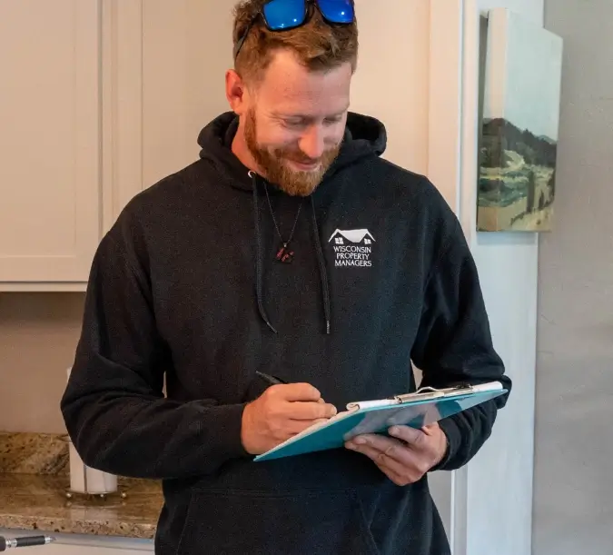 Maintenance worker of WPM filling out a form on a clipboard