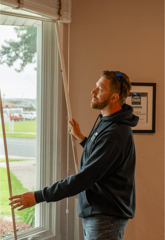 Maintenance worker installing a new window to a property